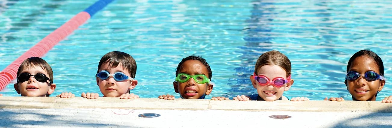 Children learning to swim in Grand Cayman with professional Thrive Fit instructors